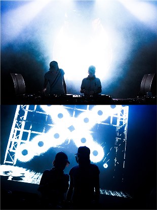 Silhouetted DJs against stage lights